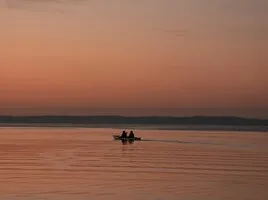 Sunrise light reflecting on calm river water